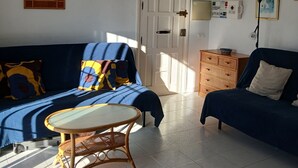 A living room with a sofa, a small round table, and a cabinet. - Modern, Spacious, and Well Equipped Apartment With Mountain And Sea Views (Nerja)
