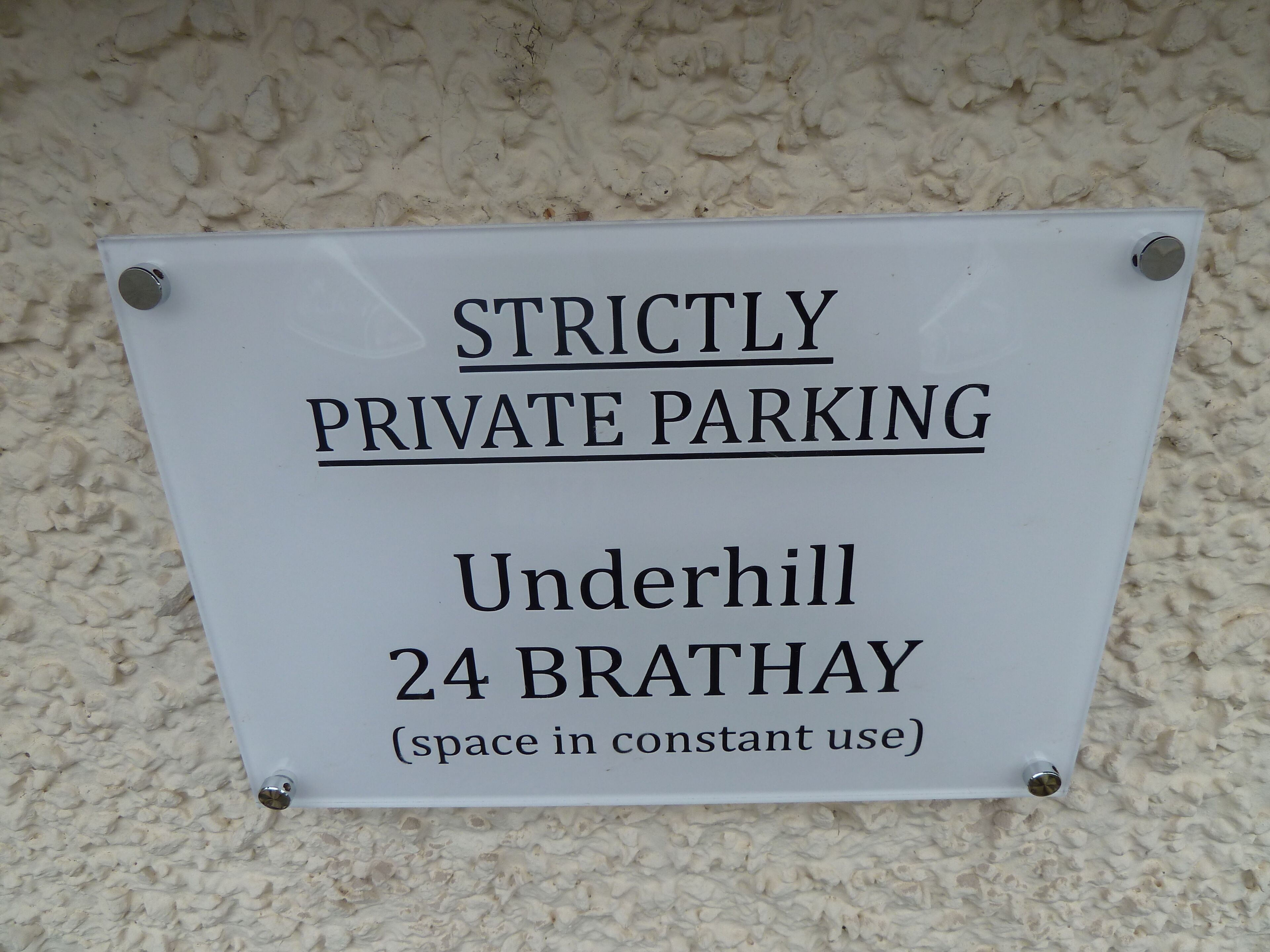A sign indicating 'STRICTLY PRIVATE PARKING' at 'Underhill 24 BRATHAY (space in constant use)'.