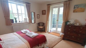 A bedroom with a bed, a dresser, a chair, and a window. - Country Cottage Set In pretty Suffolk village with 2 local pubs, dog friendly (Lower Ufford)