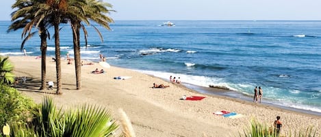 On the beach, sun-loungers