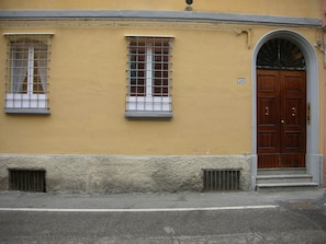 The main door with the 2 windows of the bedroom.