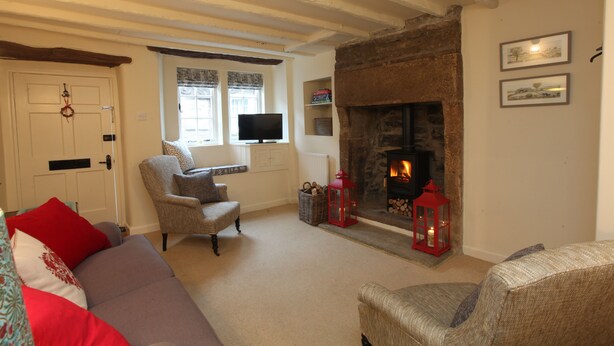 A cozy living room with a fireplace, a television, and comfortable seating.