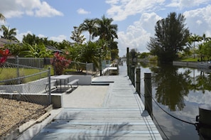 Stroll along the waterfront walkway, surrounded by serene trees and a calm body of water.
