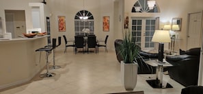 Enjoy a stylish space with a dining area for four, a comfortable sofa, and a large window with blinds.