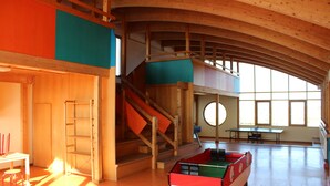 A spacious indoor area with a pool table, a staircase, and a large window allowing natural light. - Renner Vacation Home Behind the Dike in Spieka-Neufeld, Including a Beach Chair (Wurster Nordseeküste)