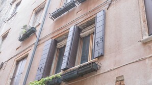 A historic building with multiple windows, some with shutters, and a visible address number '1849'. - Venetian Historic Residence at Rialto Market Square (Venezia)