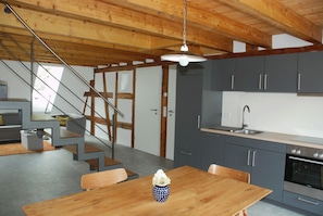 Enjoy cooking in this well-equipped kitchen with a sink, oven, and dining area.