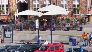 A historic brick building with multiple windows and a sign reading "zur Alten Vogtei".