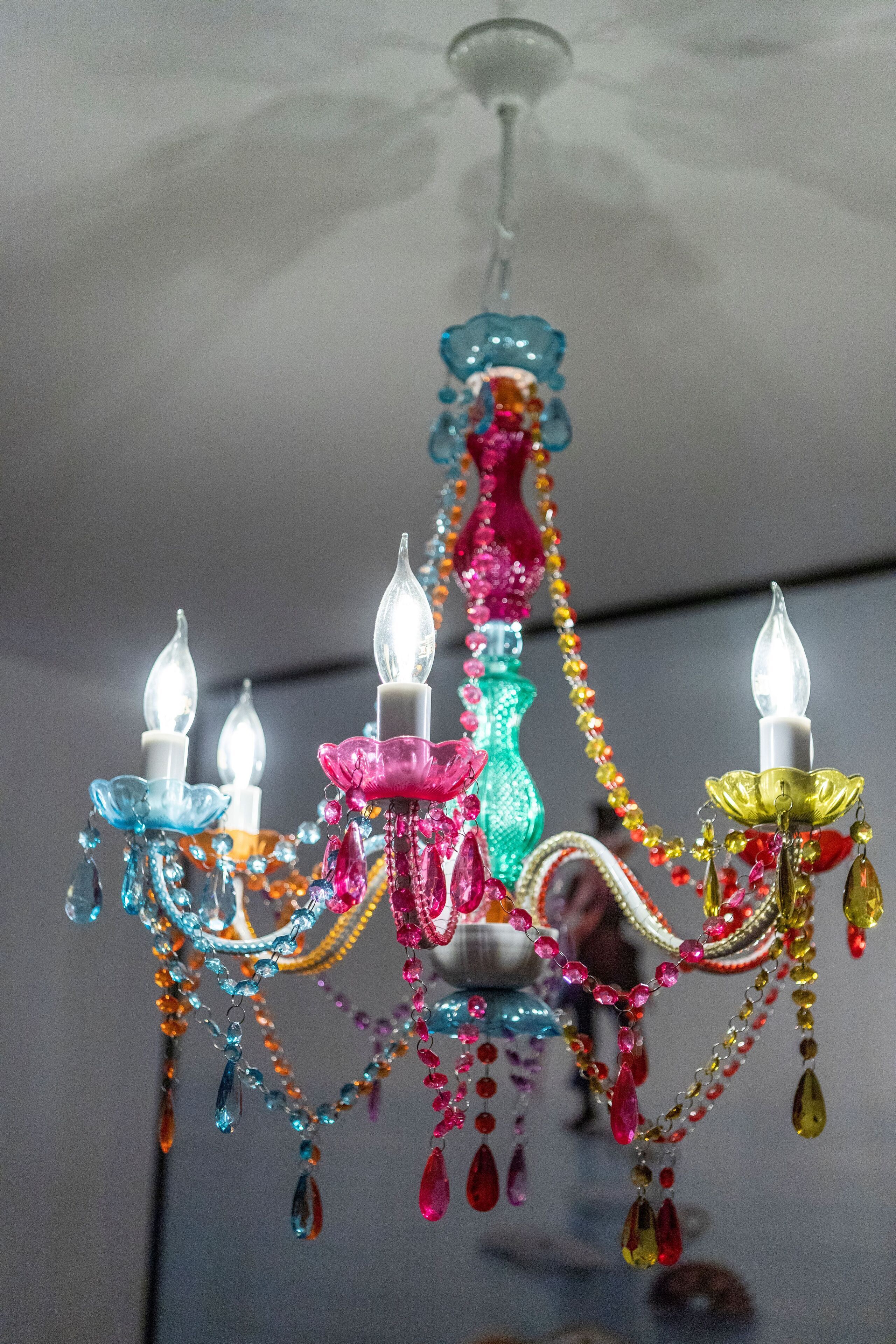 A chandelier with multiple light fixtures and decorative elements.