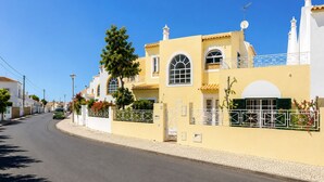 A street view with a yellow building, a tree, and a car. - 8 bedroom Villa Bella, Private Pool, Albufeira  Close to Strip & Old Town (Albufeira)