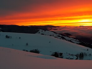 Escape to a serene mountain retreat surrounded by snow-covered slopes and majestic mountain ranges.