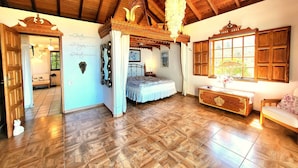 A spacious room with a high wooden ceiling, a bed, a wooden dresser, and a window with wooden shutters. - Großzüg. House with panoramic views of sea, mountains & valley + optional apartment (Tajuya)