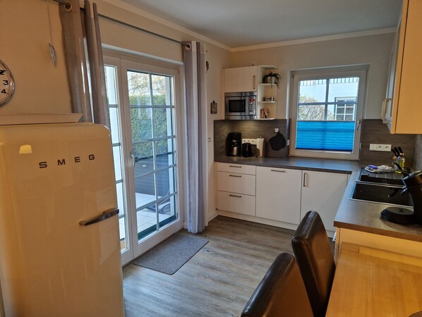A compact kitchen with a refrigerator, microwave, and coffee maker.