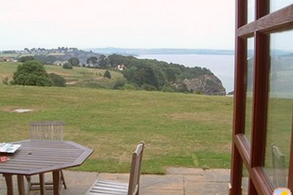 The property has an outside table and chairs on the patio area