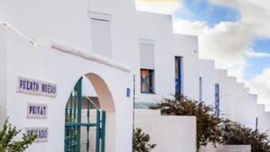 A white building with a sign reading "PUERTO NUEVO PRIVATE."