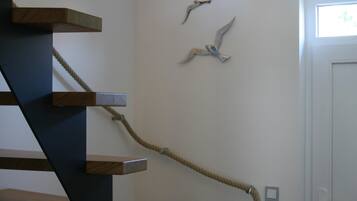Eine Treppe mit Holzstufen und einem Seilgeländer.