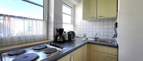 Fridge, microwave, stovetop, coffee/tea maker