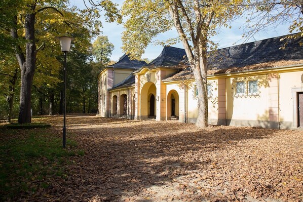 A building with a symmetrical facade, arched windows, and a central entrance.