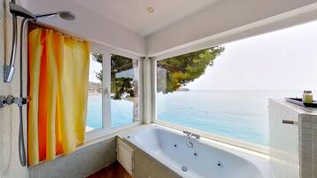 Bathtub, jetted tub, hair dryer, towels