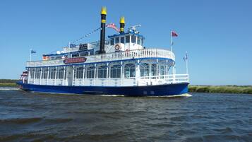 A river cruise ship named "River Star" with a white and blue color scheme, multiple decks, and a flag.