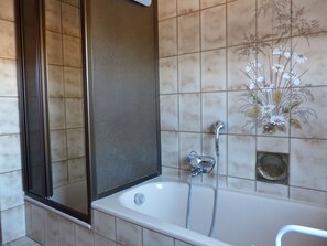 Bathtub, hair dryer, towels, soap