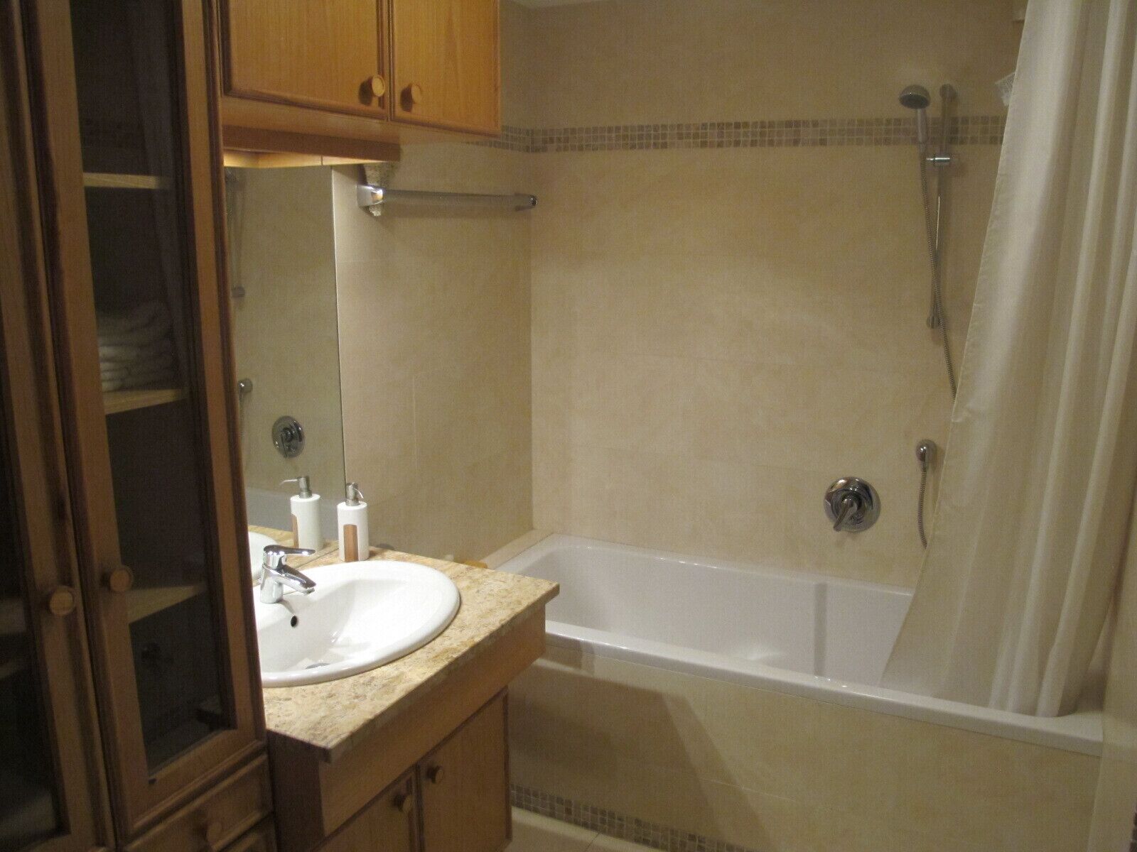 Combined shower/bathtub, towels, toilet paper