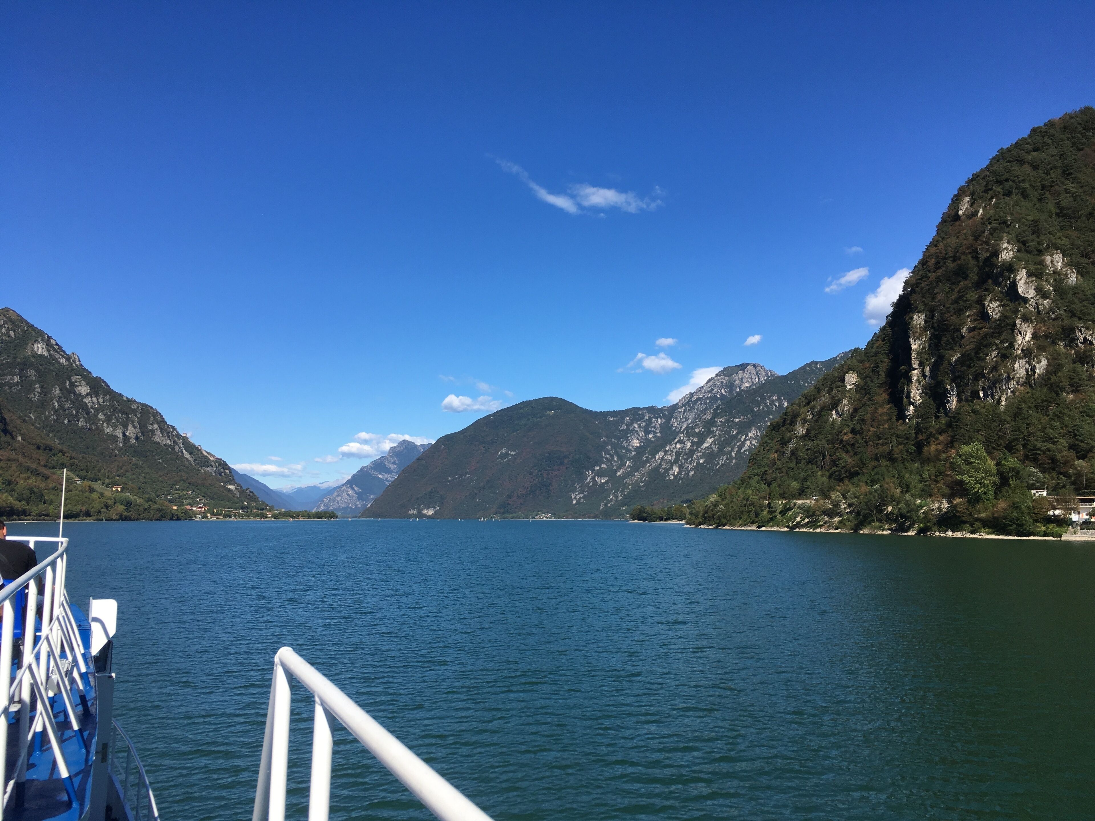 A lake with mountains in the background and a boat in the foreground.