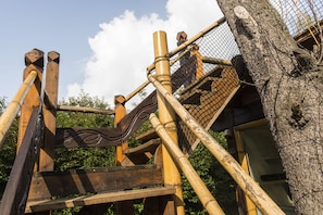 A wooden structure with a rope bridge and a netted enclosure, likely part of an outdoor attraction or park. - Apartment Casa Casimir with Elbe view balcony & large garden (for soccer/volleyball) (Dresden)