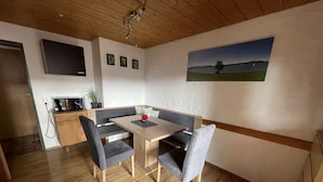 A modern kitchen with a wooden countertop, a built-in microwave, and a sink. - Apartment with panoramic views (Halblech)