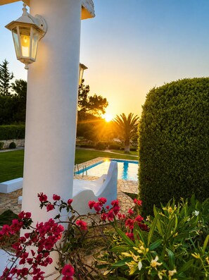 A pool area with a white column and a lantern, surrounded by well-maintained hedges and flowering plants. - Private Family Villa with Pool & Garden, 3km from Beach, Relaxing Location (Rhodos)