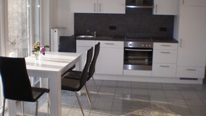 A modern kitchen with white cabinets, a stainless steel oven, and a black countertop. - High-quality-modern, approx 65sqm, gr. Garden, exclusive equipment, wirkl. gr. bathroom (Lüneburg)
