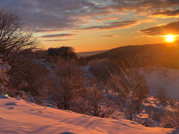 A snowy landscape with a sunset.