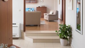 A modern living room with a sofa, a coffee table, and a potted plant. - New luxurious and modern Villa, 5 minutes from the nearest beach (Krsan)