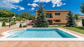 A two-story house with a swimming pool in the foreground. - New luxurious and modern Villa, 5 minutes from the nearest beach (Krsan)