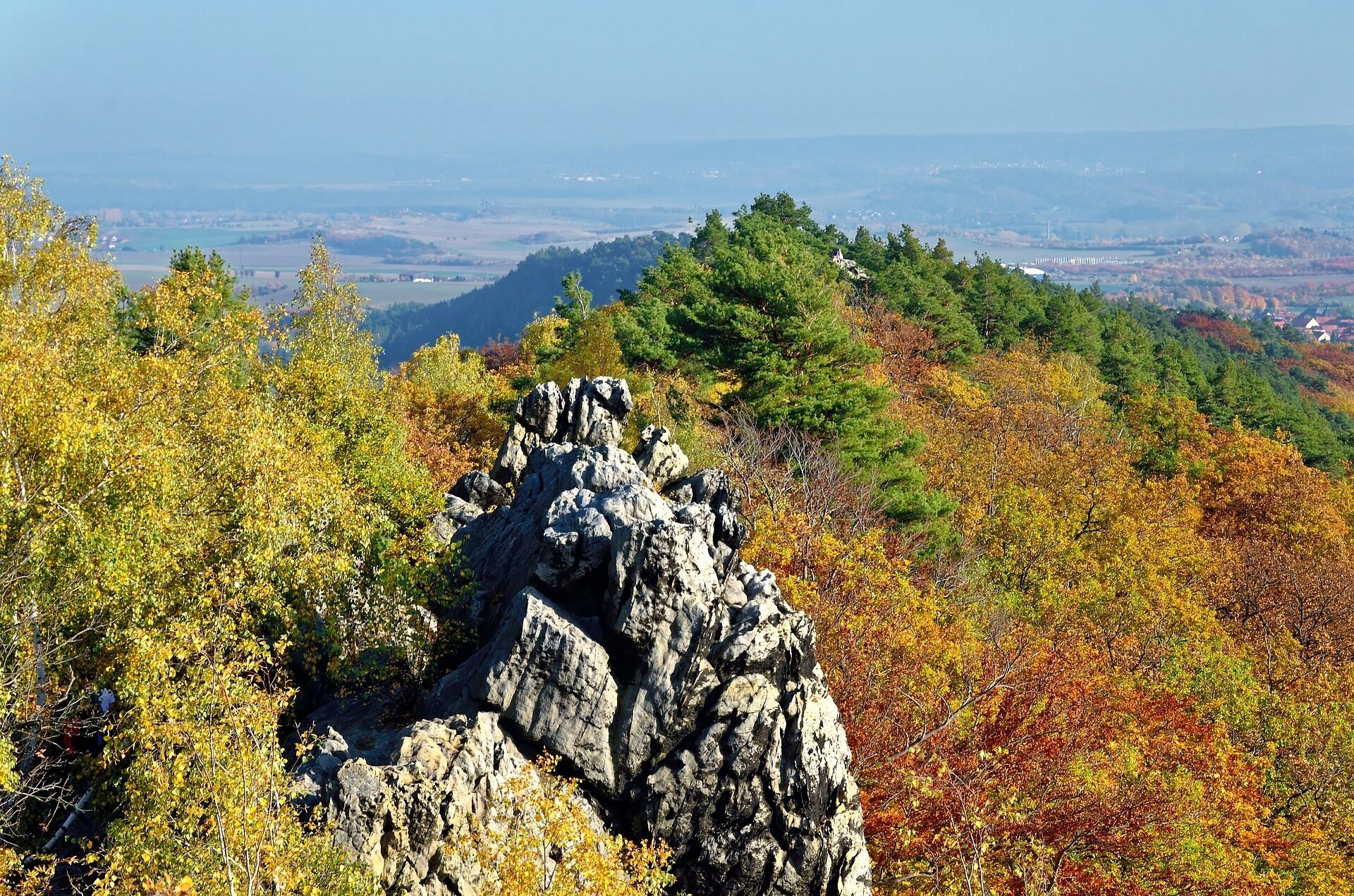 A rocky outcrop surrounded by autumn foliage.