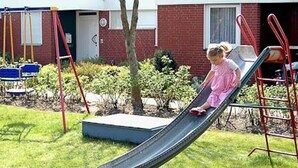 Een kind glijdt van een glijbaan.