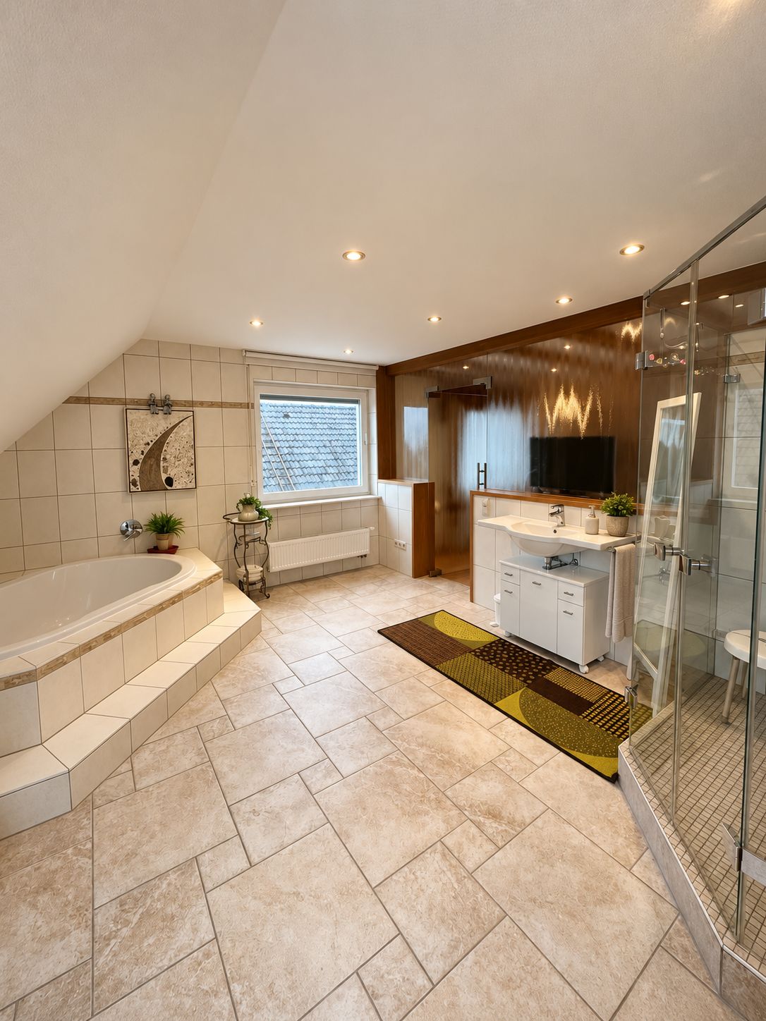 A modern bathroom with a freestanding bathtub, a glass-enclosed shower, and a vanity with a sink and mirror.