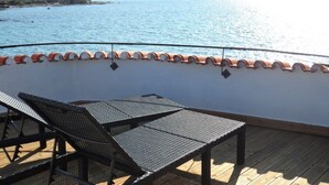 A sunlit outdoor deck with a pool, lounge chairs, and a view of the sea. - unique historical STONE TOWER DIRECTLY BY THE SEA! carefully restored (Umag)
