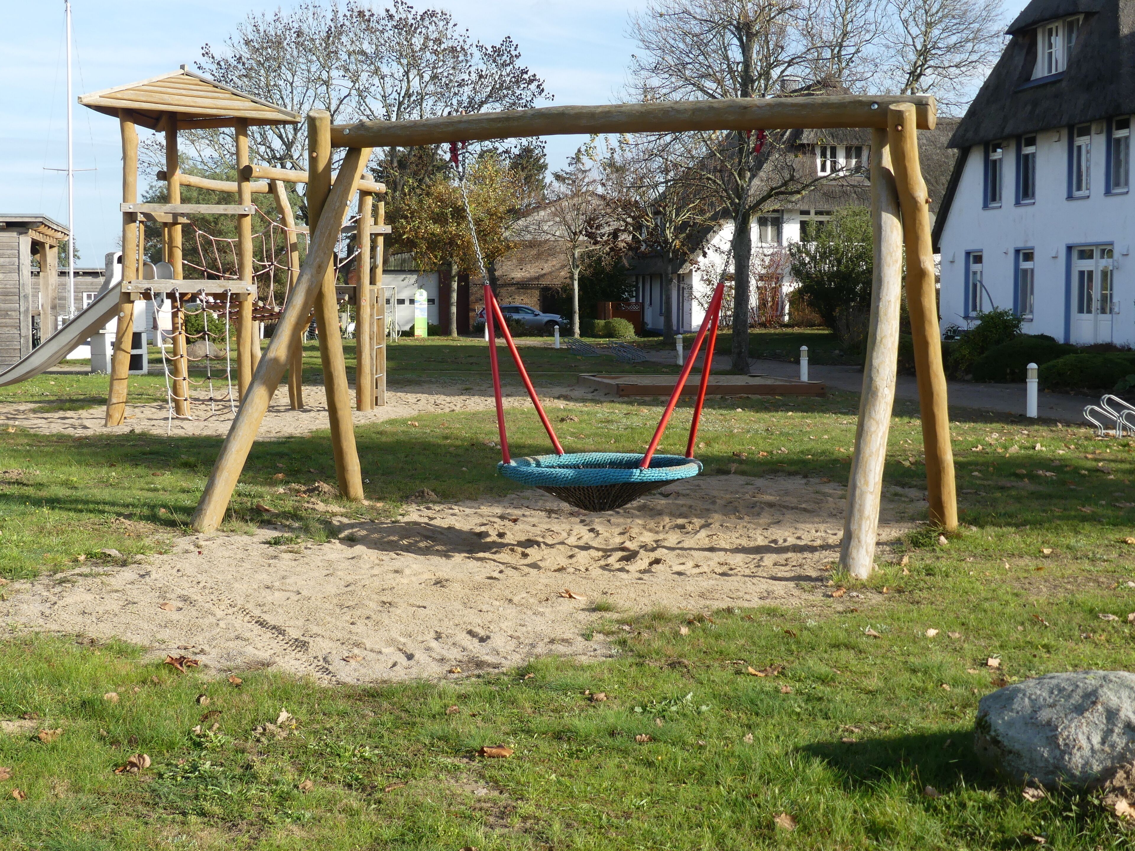 A playground with a swing set and a slide.