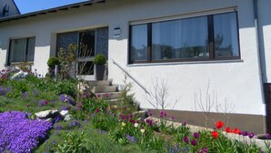 A white building with large windows and a stone staircase leading to the entrance. - Welcome Holiday home Schmitz No. 2, for 2 to 4 people.  with Wi-Fi (Pünderich/Mosel)