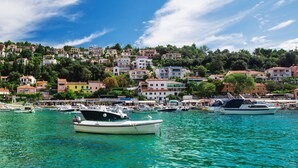 A coastal town with colorful buildings and boats docked in the harbor. - Villa Primela with breathtaking sea views and private pool (Labin)