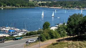 A marina with sailboats, a parking area, and a road leading to the water.