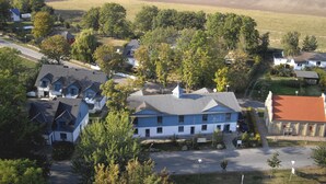 A small town with a mix of residential and commercial buildings, including a hotel with a blue facade and a red-roofed building. - Pure nature - attractive apartment on Cape Arkona, the northernmost point of Rügen (Putgarten)
