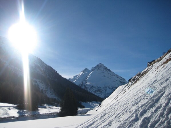 A snow-covered mountain landscape with a clear sky.
