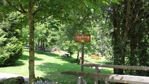 A wooden sign with the word "Spielwiese" in a park setting. - Pure nature - detached, quietly situated vacation home for 4 people (Feldberg)