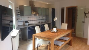 A modern kitchen with a dining area.