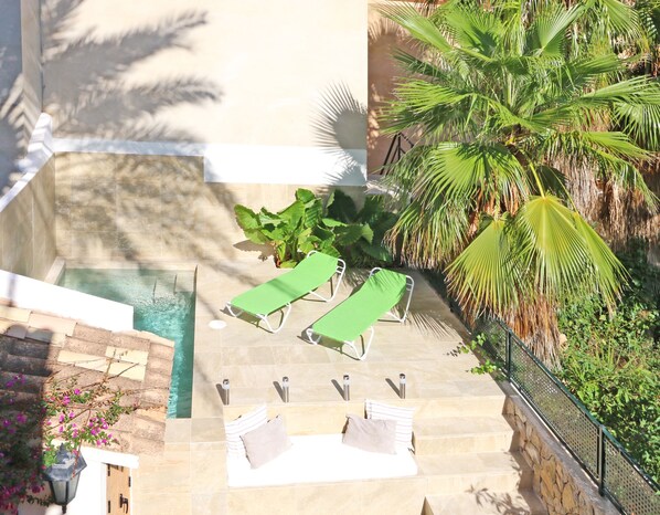 A pool area with lounge chairs and a staircase leading to a higher level. - Ca Ses Nines: Beautiful oasis in a quiet location, swimming pool, wifi, climate (Selva)
