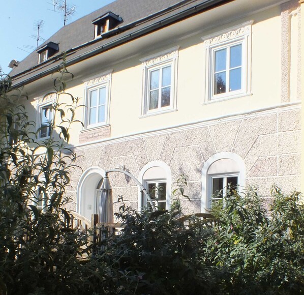 A building with multiple windows and a stone facade.