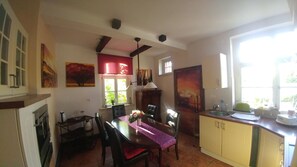 A cozy kitchen with a dining table, chairs, and a window providing natural light.