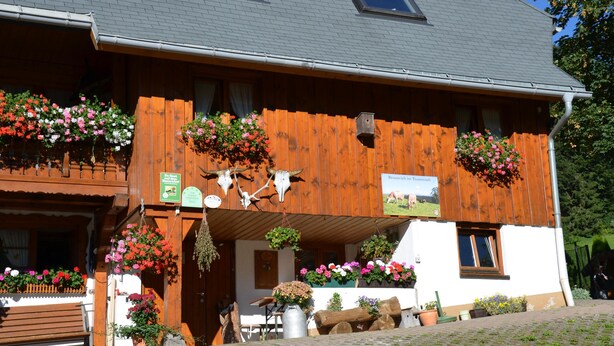 A wooden building with flower boxes and a sign indicating a restaurant. - Freiburg, Southern Black Forest, Schauinsland Hofsgrund, farm houses, (Oberried)